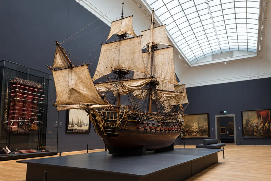 Historic model ship displayed in a Rijksmuseum gallery